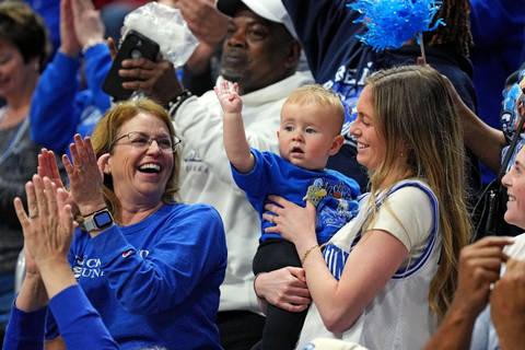 Creighton Bluejays guard Steven Ashworth’s wife, Peyton Ashworth, holds their son Tommy Jay Ashworth during the second half of the game between the Louisville Cardinals and the Creighton Bluejays in the first round of the NCAA Tournament at Rupp Arena.